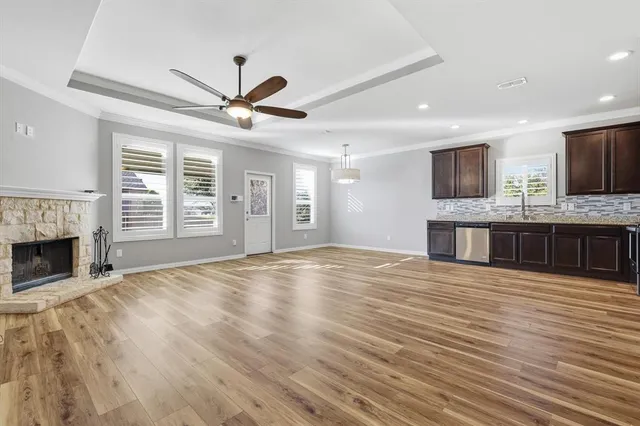 a view of an empty room with a fireplace and a window
