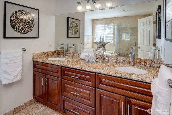 a bathroom with a granite countertop sink a mirror and vanity
