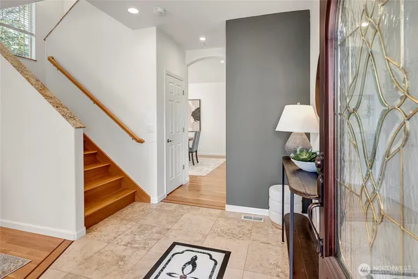 a view of entryway and hall with wooden floor