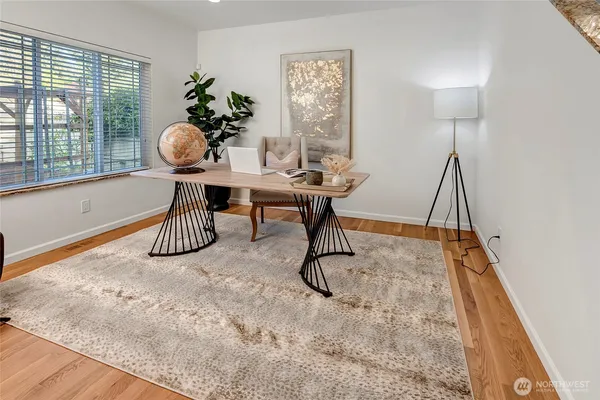 a dining room with furniture and wooden floor