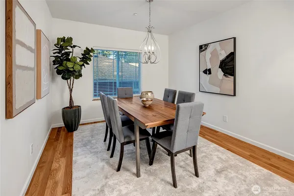 a view of a dining room with furniture and chandelier