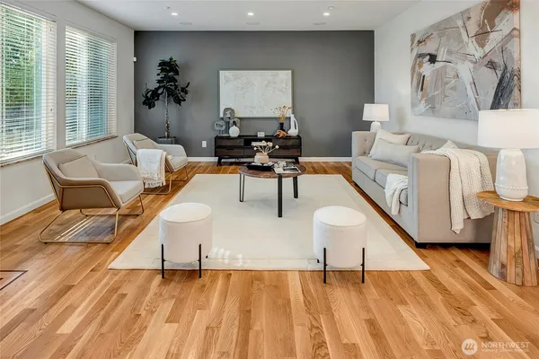a living room with furniture and wooden floor