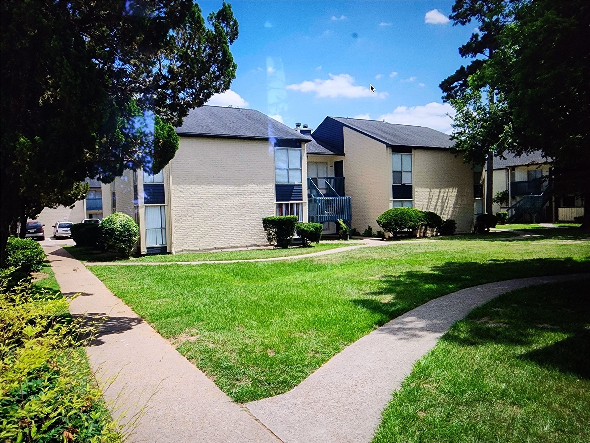2402 Bammelwood Drive, Unit 226 Houston, TX 77014 - Photo 2 of 8 a front view of a house with a garden and plants