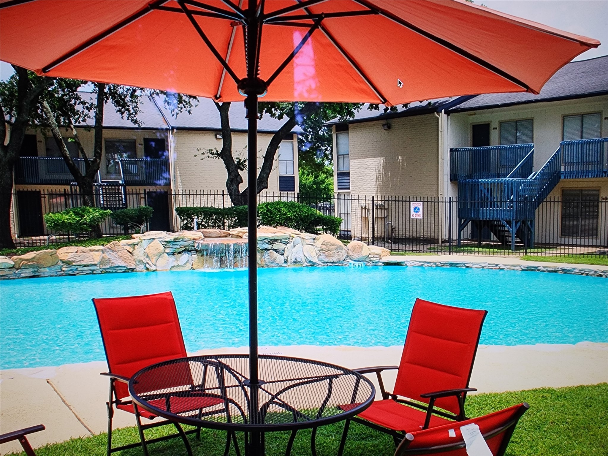 2402 Bammelwood Drive, Unit 226 Houston, TX 77014 - Photo 5 of 8 a patio with a table and chairs