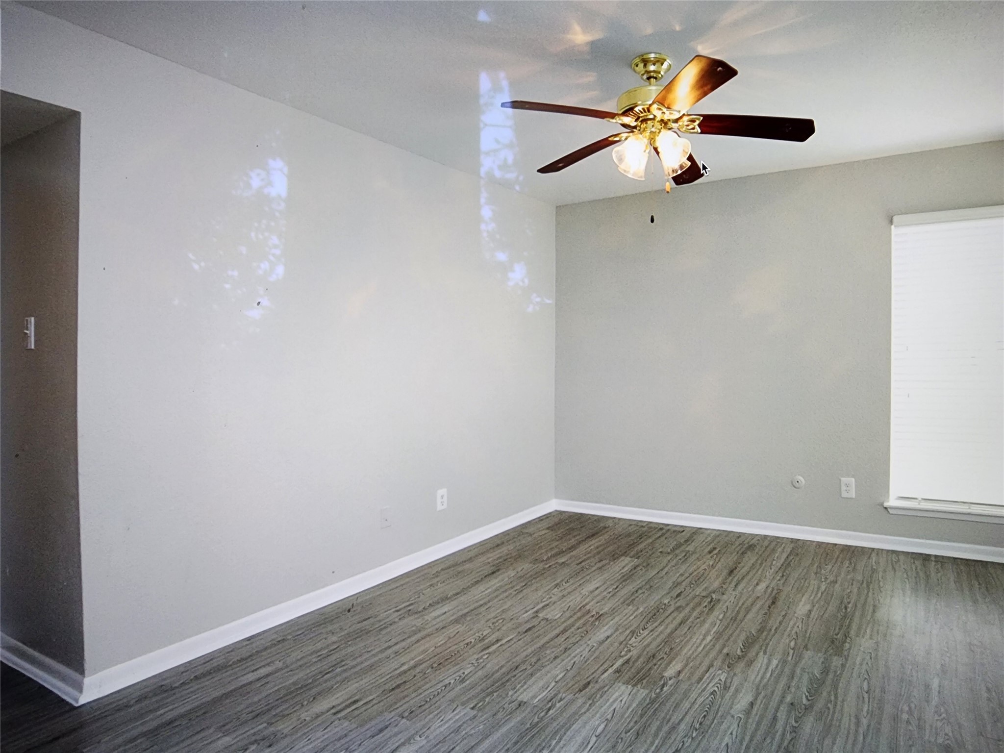 2402 Bammelwood Drive, Unit 226 Houston, TX 77014 - Photo 7 of 8 a view of a room with wooden floor and a ceiling fan