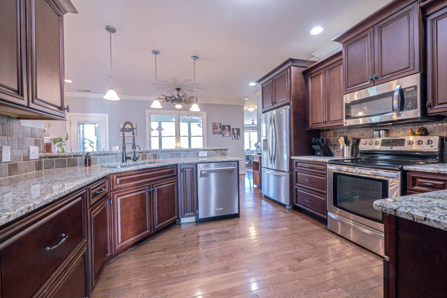 5125 Old Harding Road Franklin, TN 37064 - Photo 12 of 50 a large kitchen with stainless steel appliances granite countertop a stove a sink dishwasher and a refrigerator with wooden floor