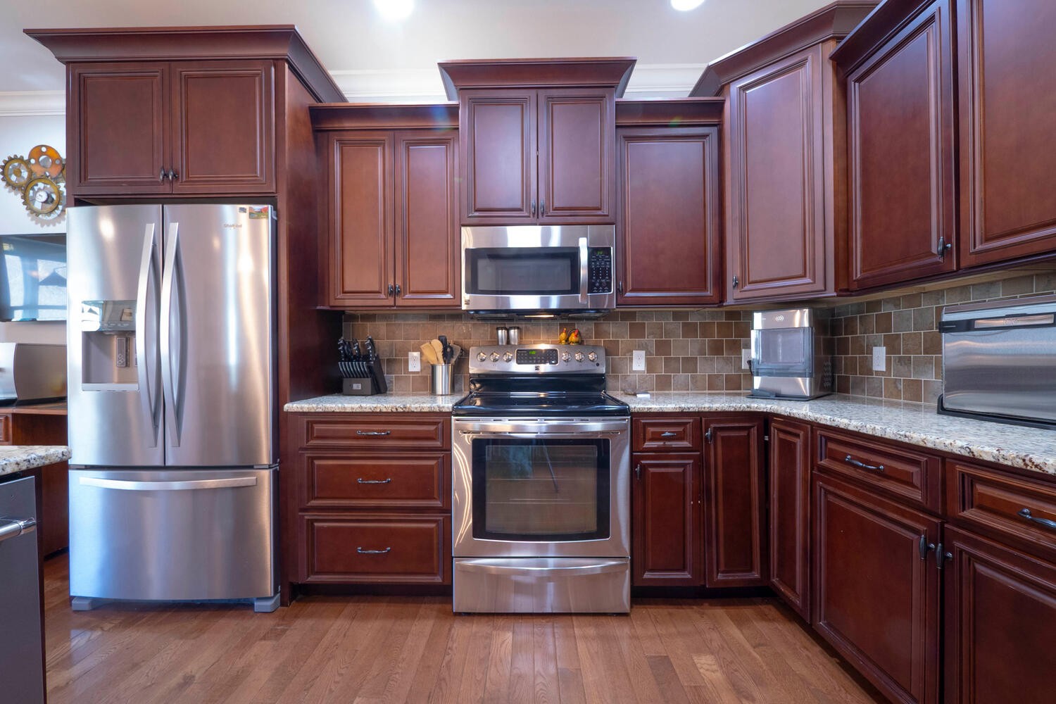 5125 Old Harding Road Franklin, TN 37064 - Photo 13 of 50 a kitchen with granite countertop wooden floors stainless steel appliances and cabinets