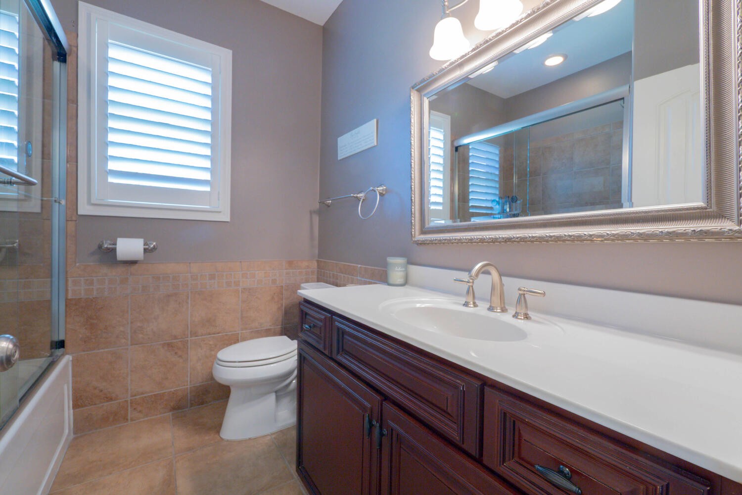 5125 Old Harding Road Franklin, TN 37064 - Photo 29 of 50 a bathroom with a sink a toilet a mirror and a window
