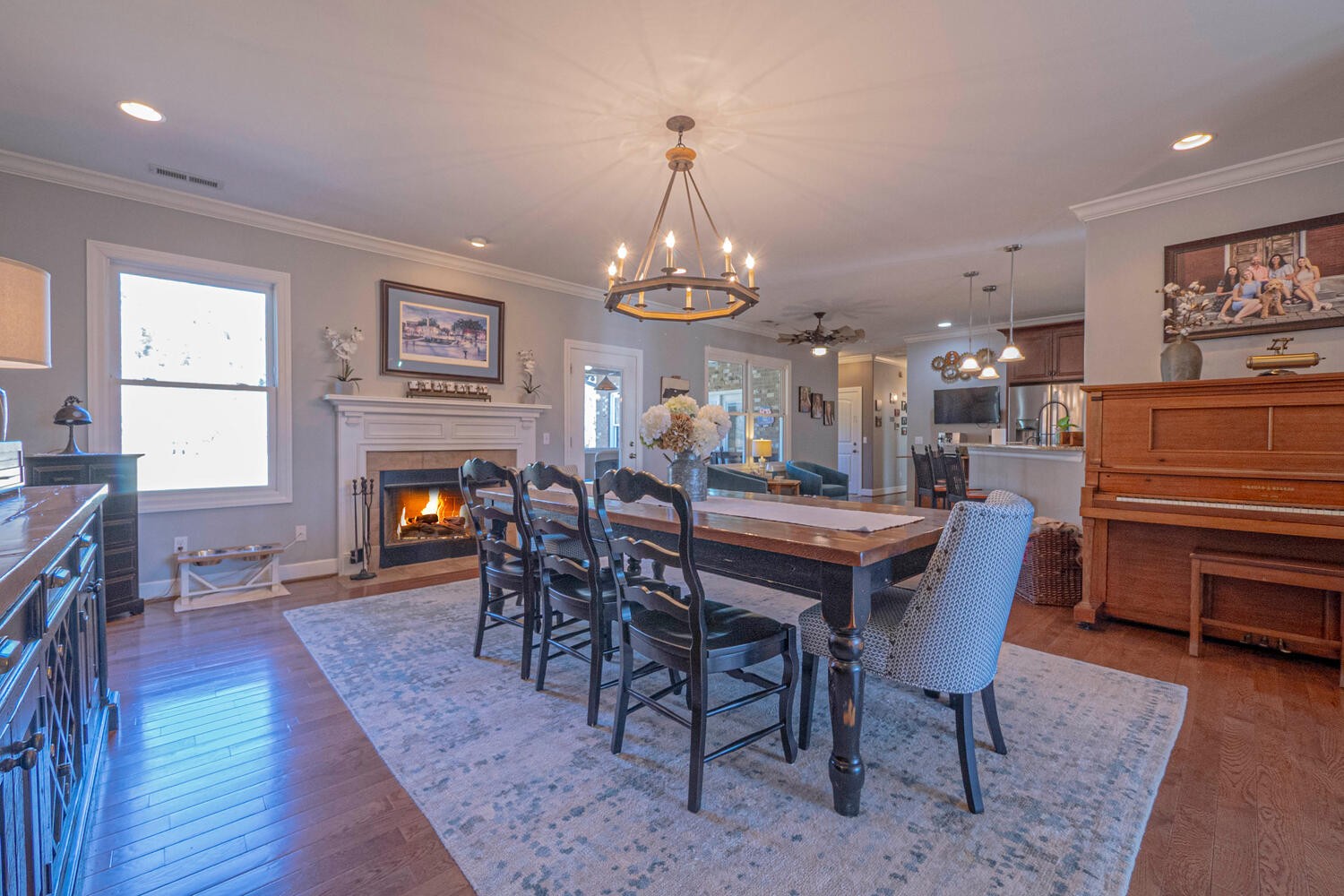 5125 Old Harding Road Franklin, TN 37064 - Photo 10 of 50 a dining room with wooden floor a chandelier a wooden table and chairs