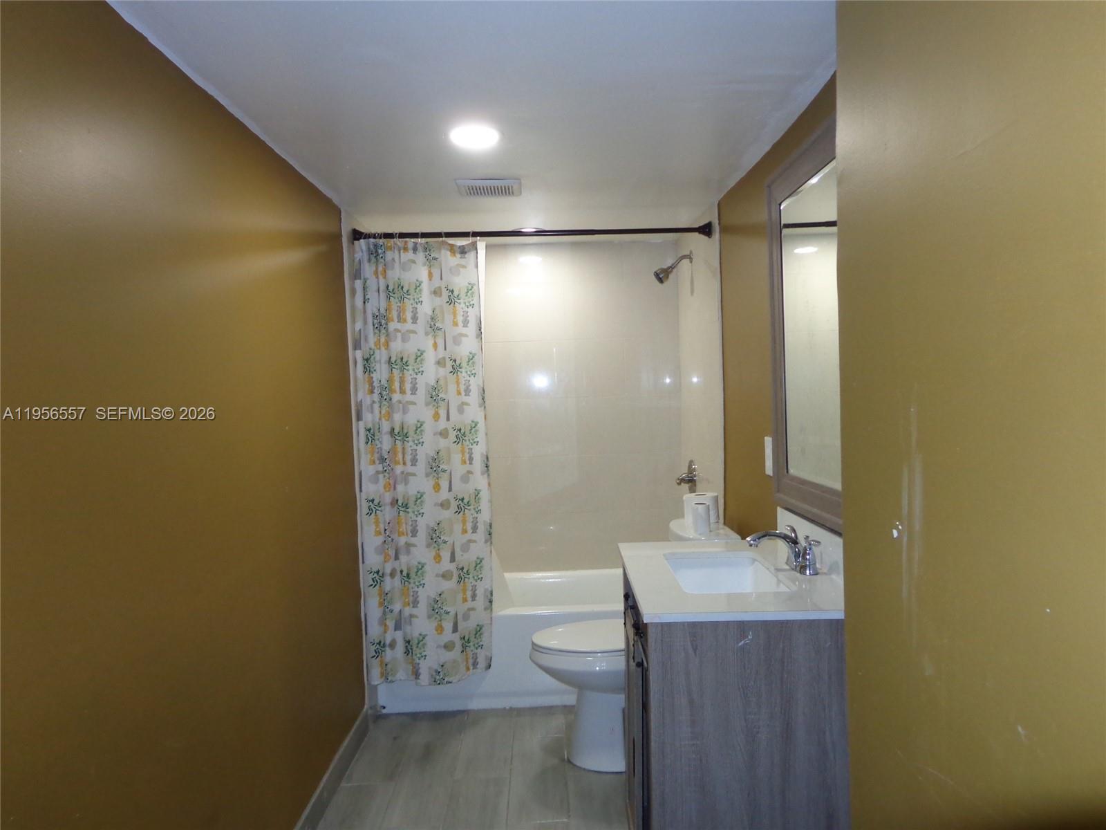 4172 Inverrary Drive, Unit 110 Lauderhill, FL 33319 - Photo 13 of 25 a bathroom with a granite countertop sink a toilet and shower