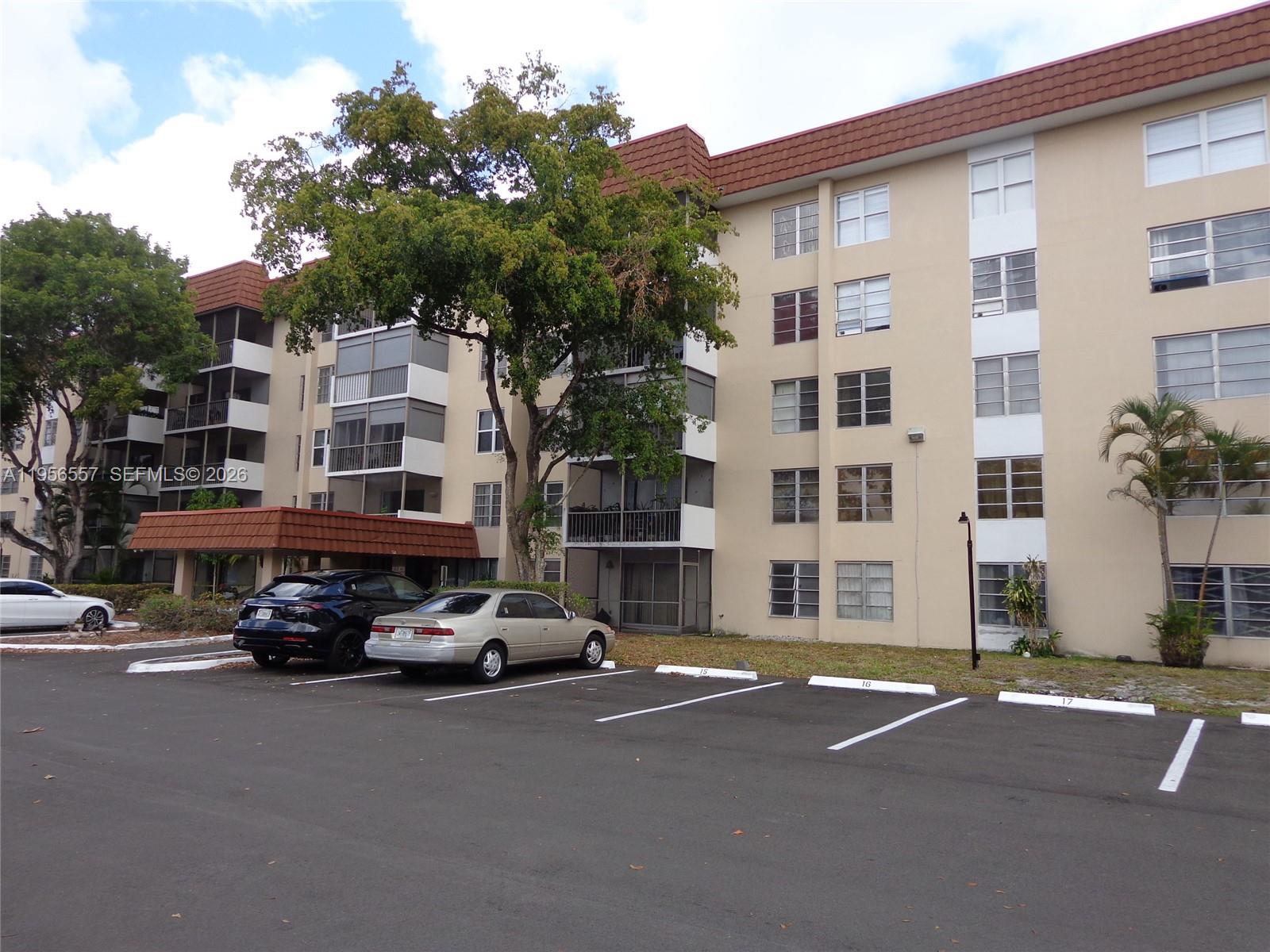 4172 Inverrary Drive, Unit 110 Lauderhill, FL 33319 - Photo 22 of 25 a car parked in front of a building