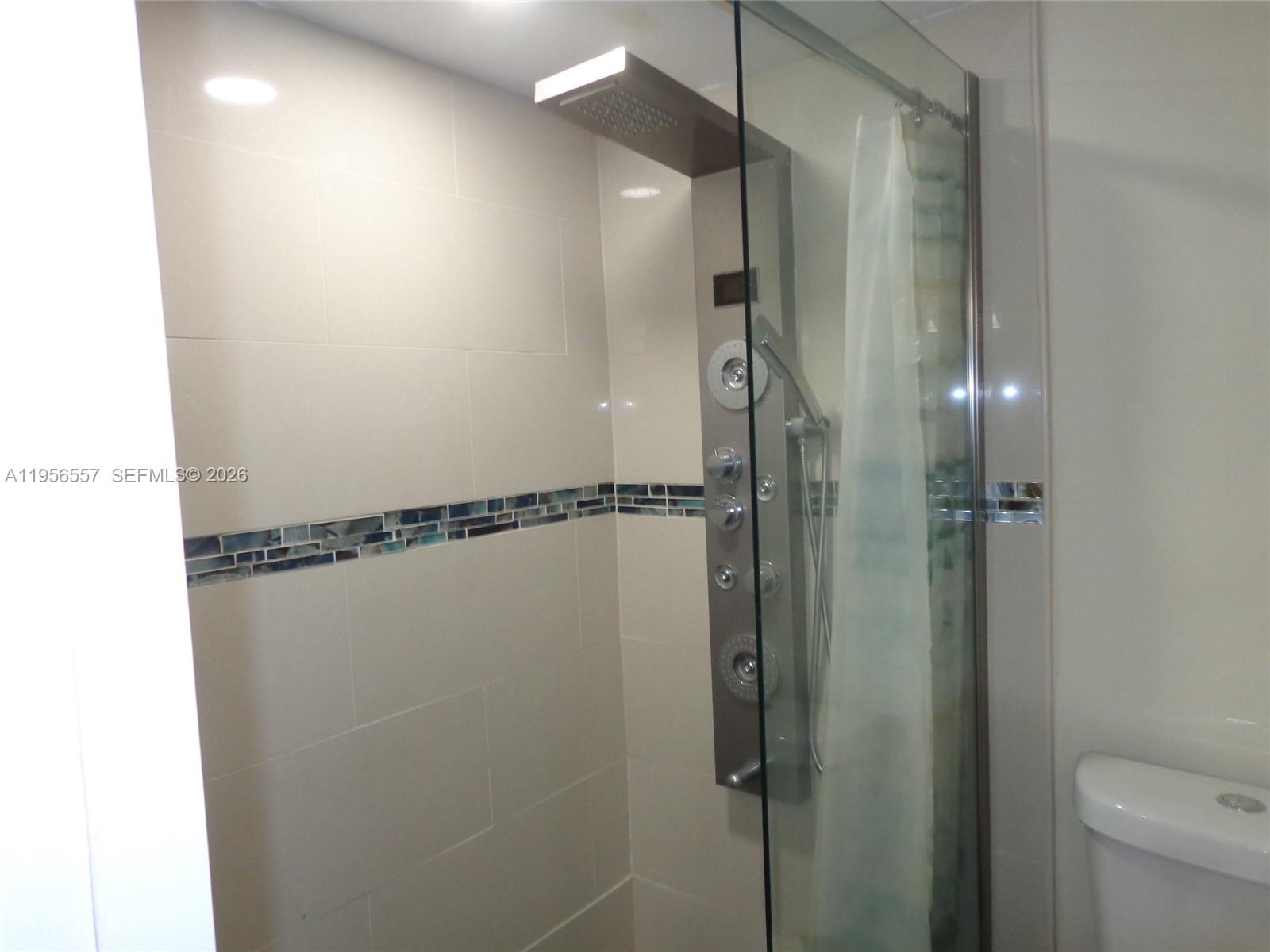 4172 Inverrary Drive, Unit 110 Lauderhill, FL 33319 - Photo 8 of 25 a bathroom with a shower and a toilet
