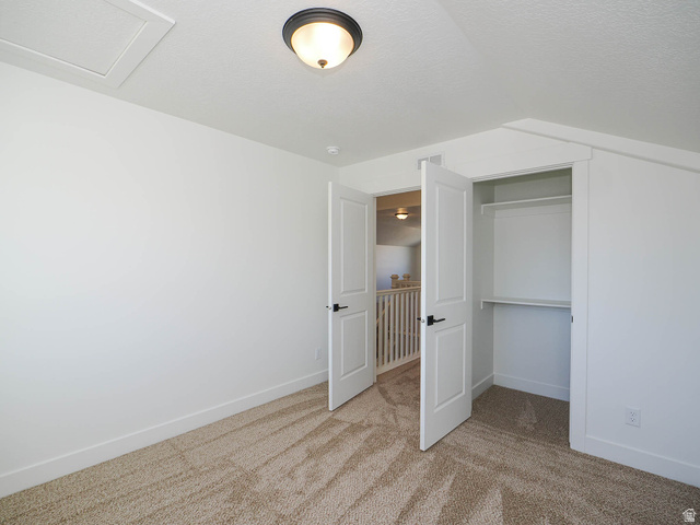 3938 North Wood Road Eagle Mountain, UT 84005 - Photo 38 of 55 Unfurnished bedroom with a closet and light carpet