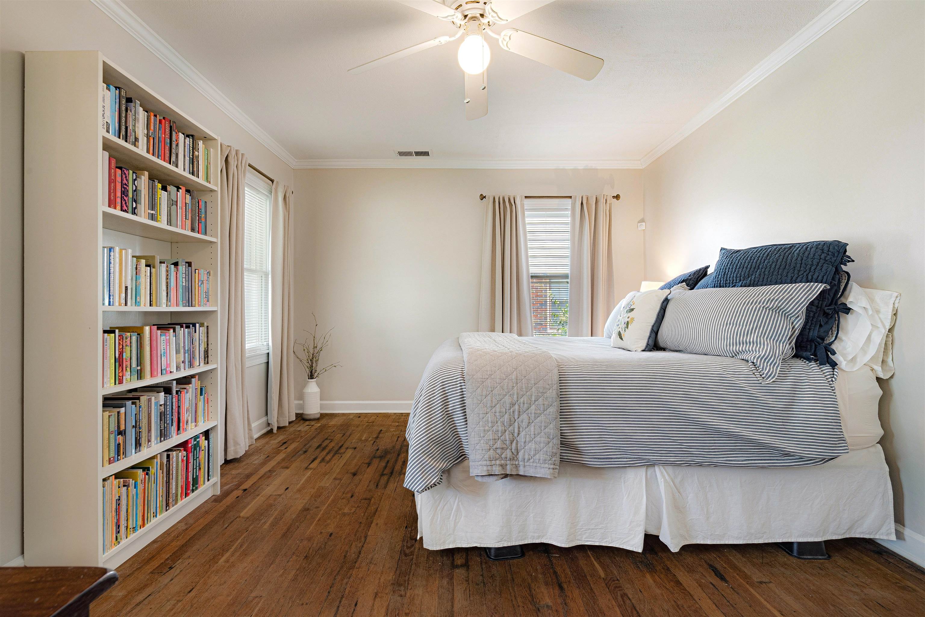 5019 Princeton Road Memphis, TN 38117 - Photo 19 of 25 a bedroom with a large bed and a book shelf