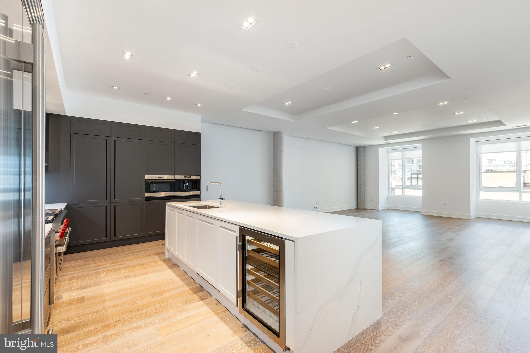 a large kitchen with a stove a sink dishwasher and a refrigerator
