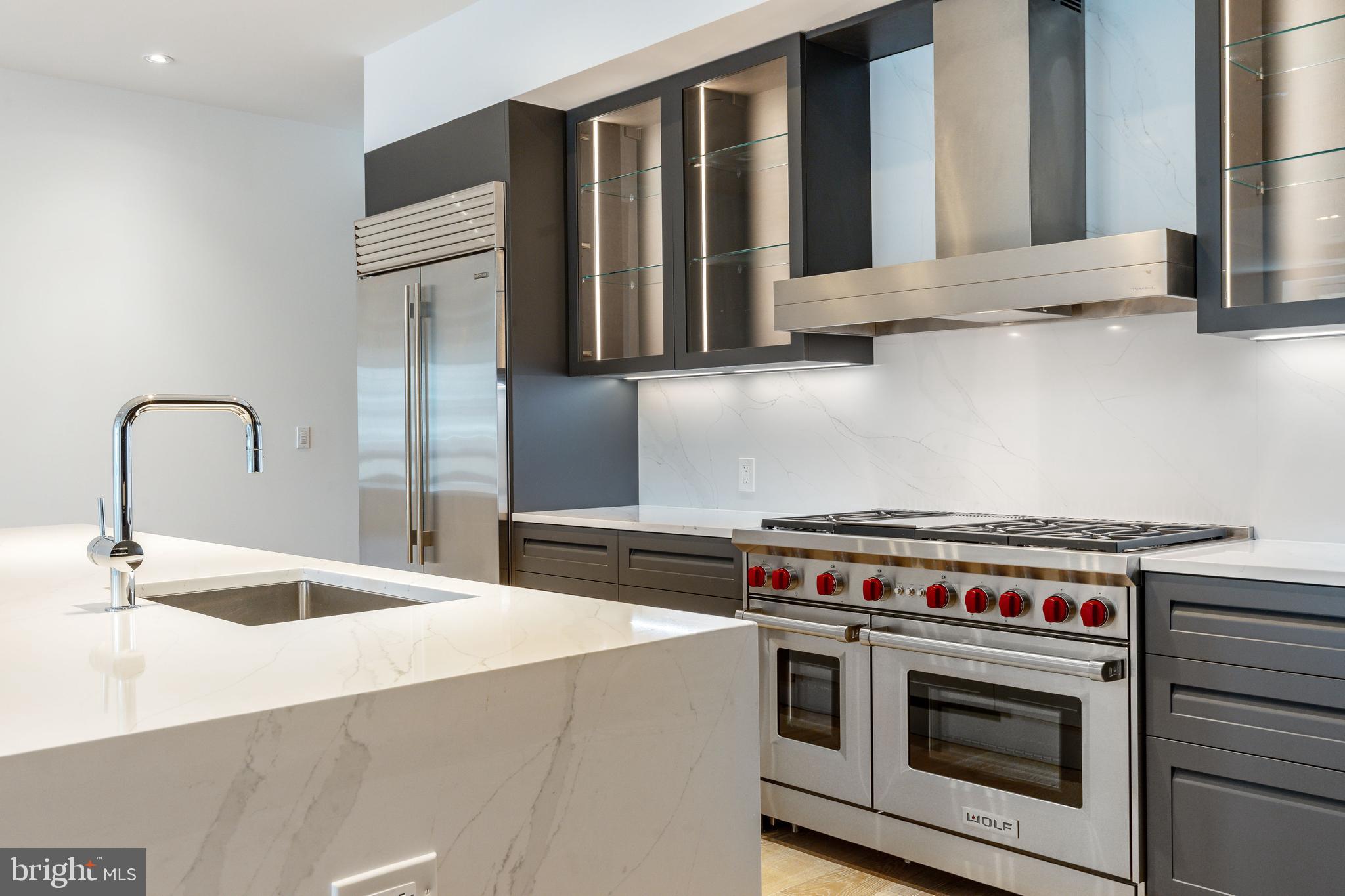 2108 Walnut Street, Unit 401 Philadelphia, PA 19103 - Photo 6 of 34 a kitchen with granite countertop a stove and a sink