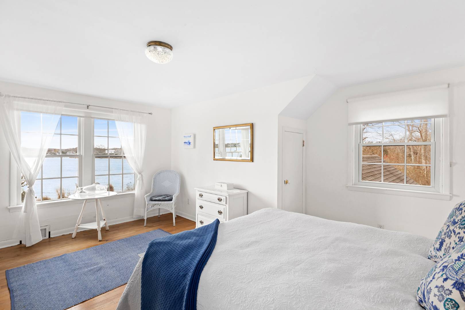 69 Ferry Road Sag Harbor, NY 11963 - Photo 16 of 17 a bedroom with a bed and wooden floor