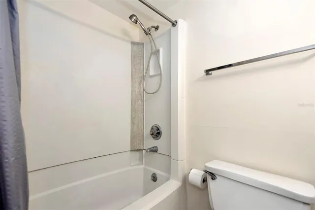 a bathroom with a shower and a toilet