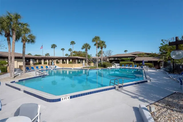 swimming pool view with a seating space