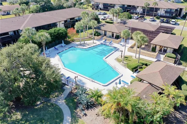 an aerial view of a house with a swimming pool yard and outdoor seating