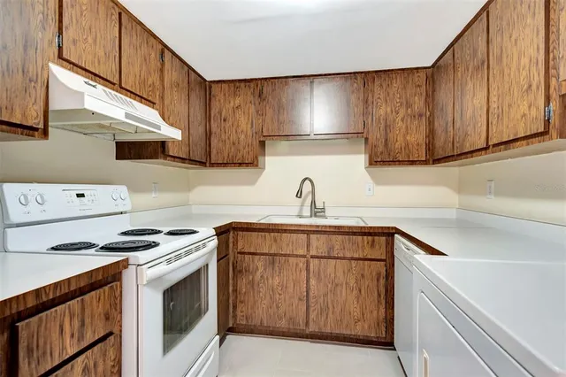 a kitchen with appliances cabinets and a sink