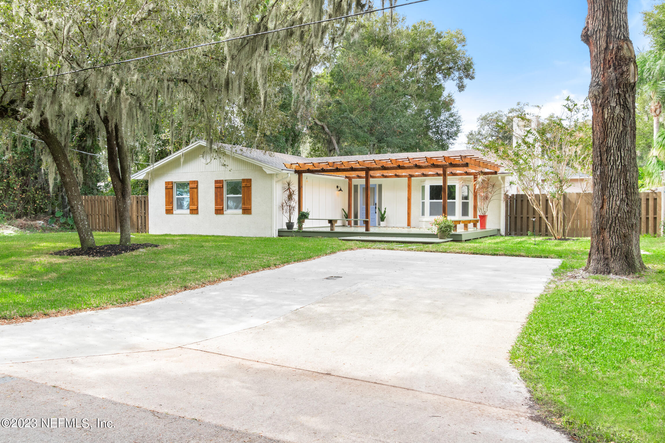 120 Hawthorne Road St. Augustine, FL 32086 - Photo 24 of 36 front view of a house next to a yard and trees