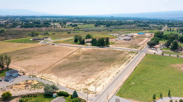 an aerial view of residential houses with outdoor space and river