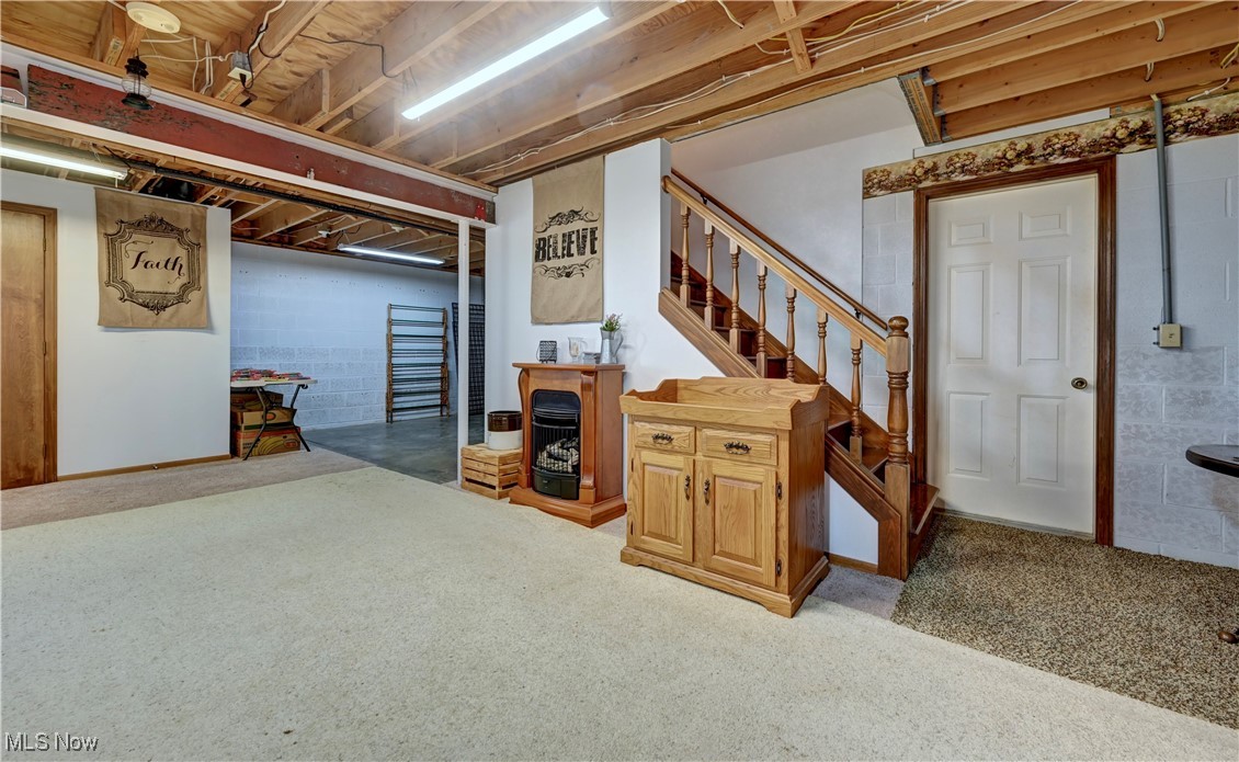 17198 Harrison Road Navarre, OH 44662 - Photo 40 of 45 Finished below grade area featuring concrete block wall, stairway, and carpet flooring