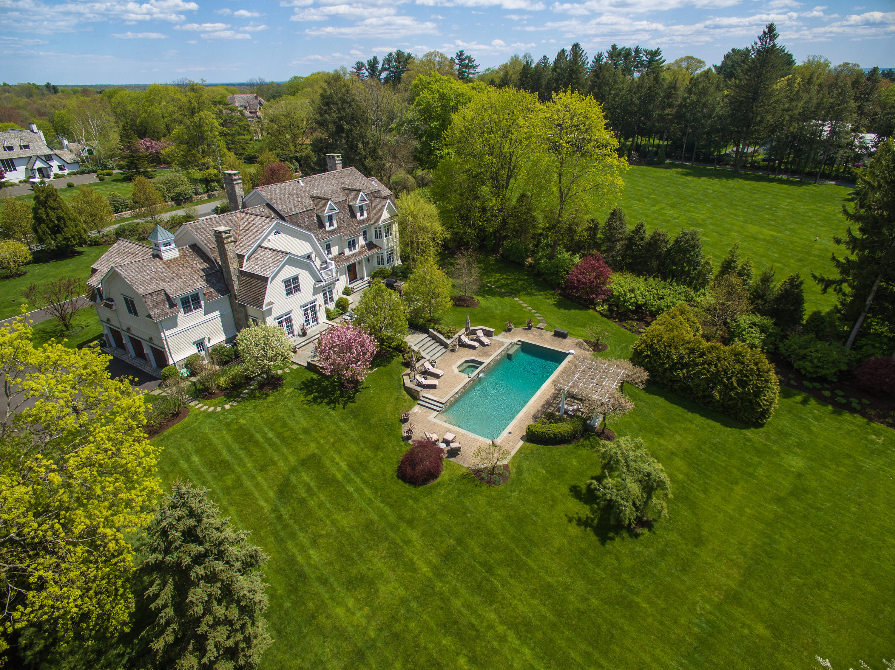92 Rosebrook Road New Canaan, CT 06840 - Photo 1 of 44 an aerial view of a house with a garden