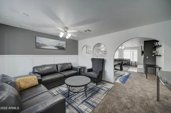 a living room with furniture a rug and a fireplace