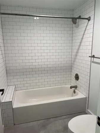 a bathroom with a bathtub and shower