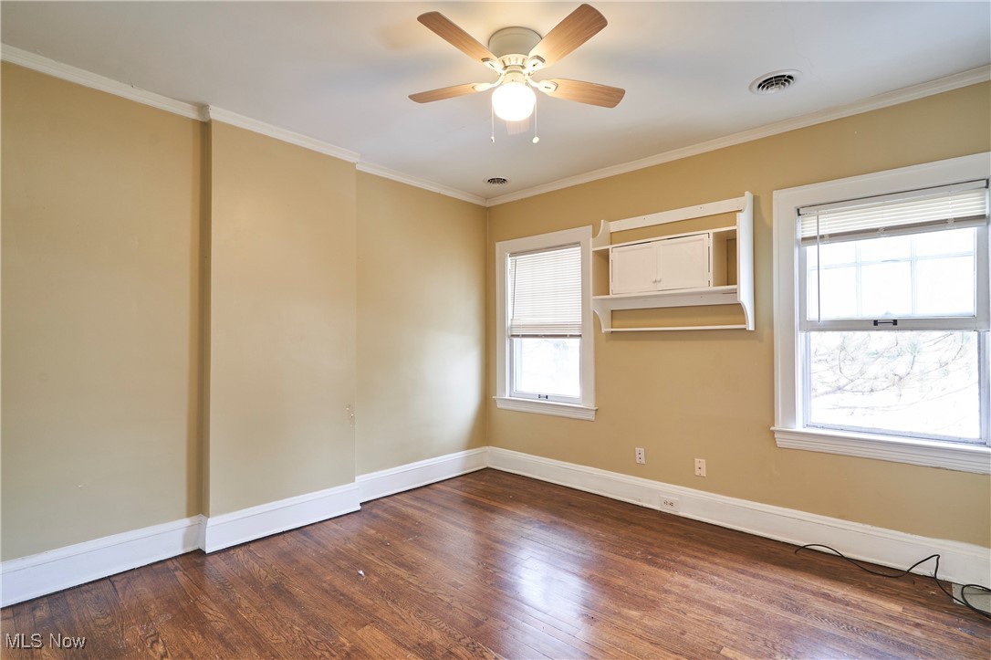 2152 Middlefield Road Cleveland, OH 44106 - Photo 14 of 50 Spare room featuring ornamental molding, ceiling fan, and dark hardwood / wood-style flooring