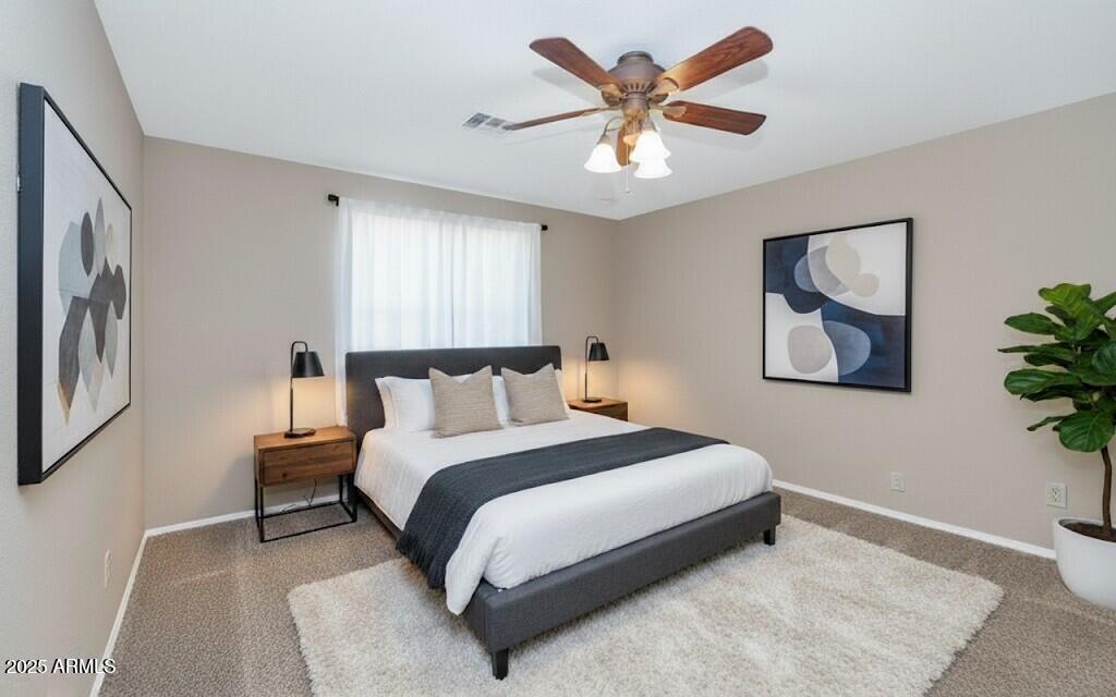 5726 North 10th Street, Unit 5 Phoenix, AZ 85014 - Photo 15 of 39 a bedroom with a large bed and a chandelier