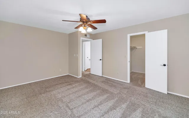a view of an empty room with a fan