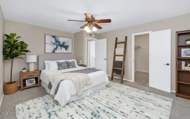 a bedroom with a large bed and a chandelier