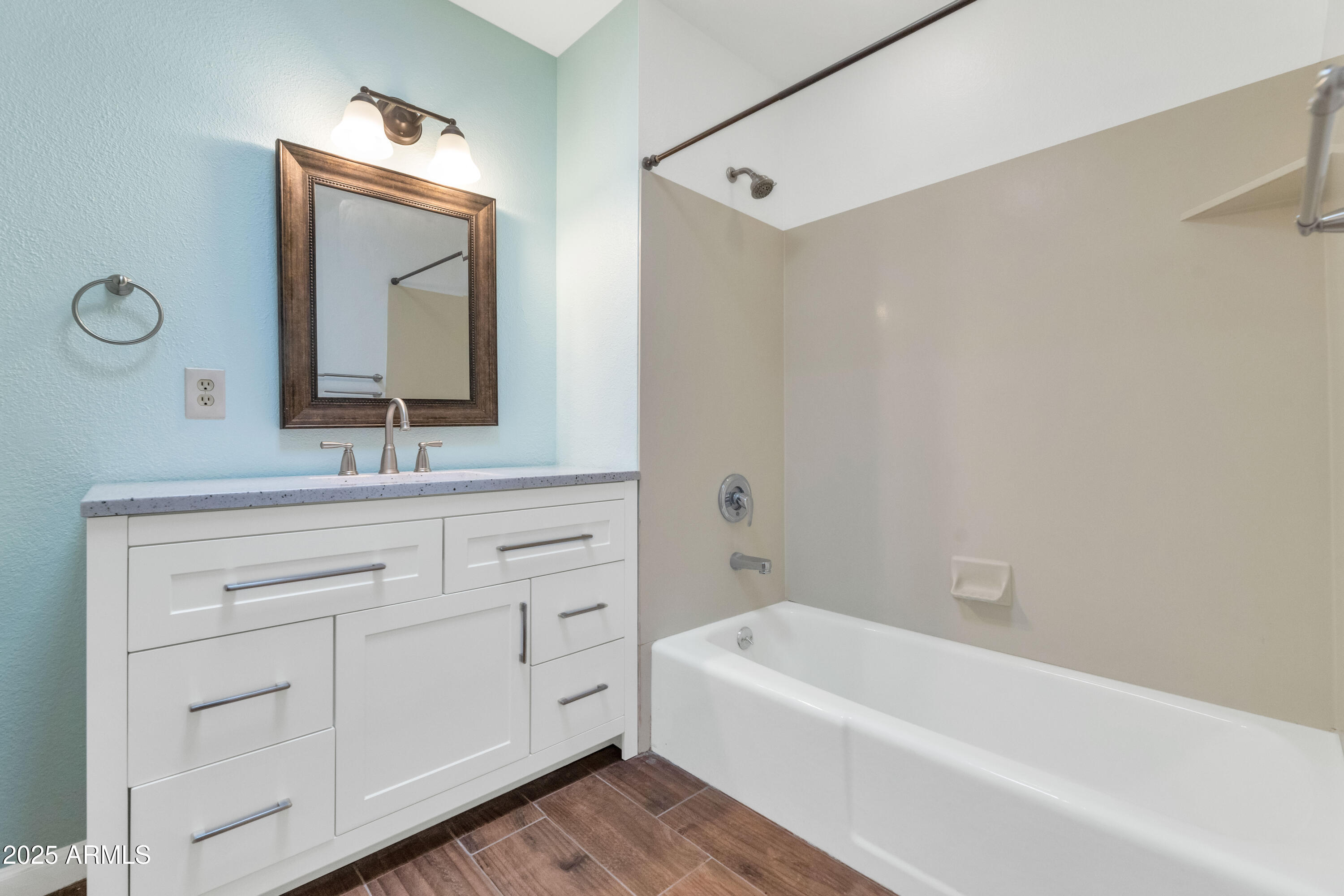 5726 North 10th Street, Unit 5 Phoenix, AZ 85014 - Photo 19 of 39 a bathroom with a bathtub sink and mirror