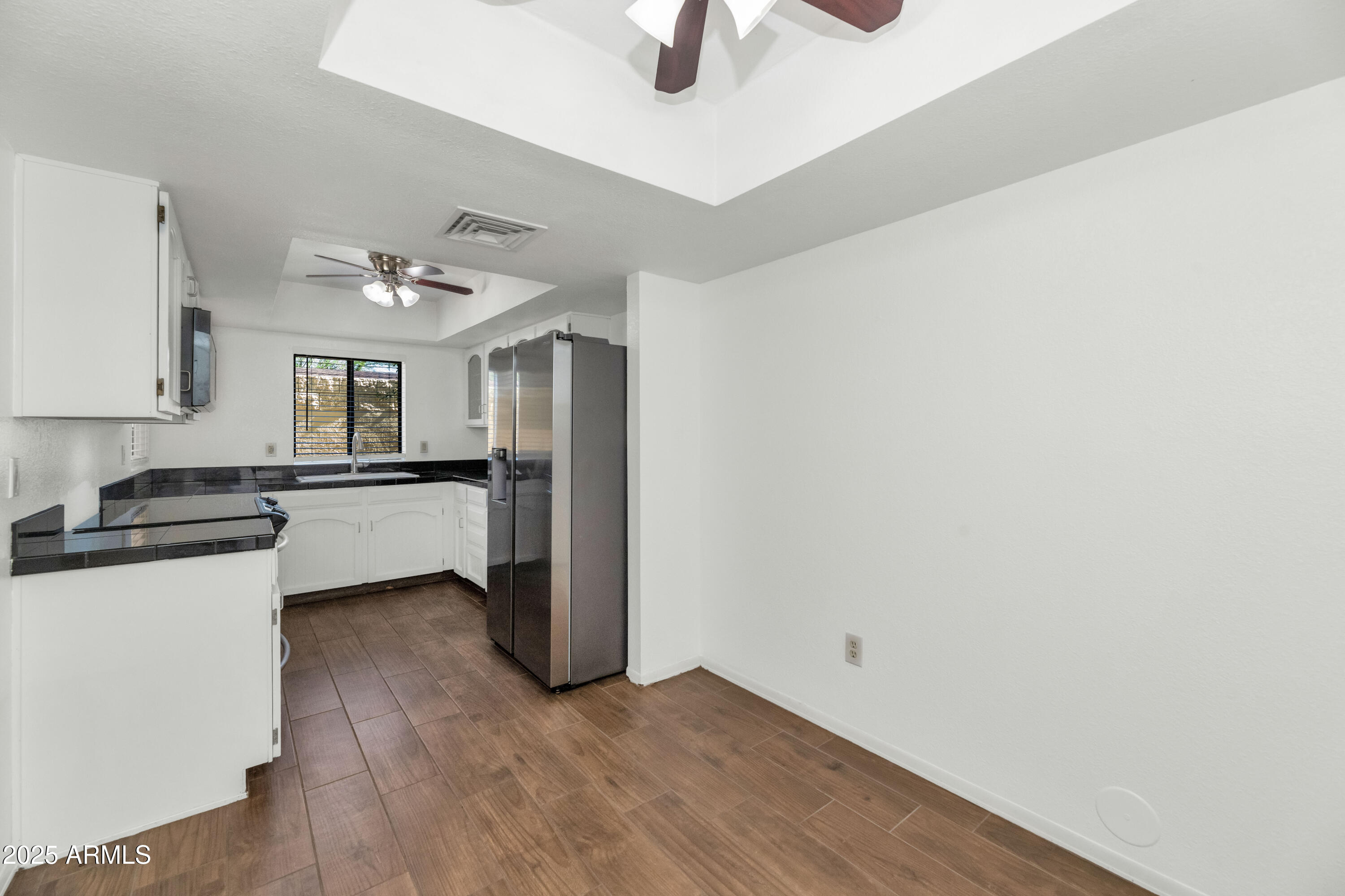 5726 North 10th Street, Unit 5 Phoenix, AZ 85014 - Photo 24 of 39 a kitchen with granite countertop a sink cabinets and stainless steel appliances