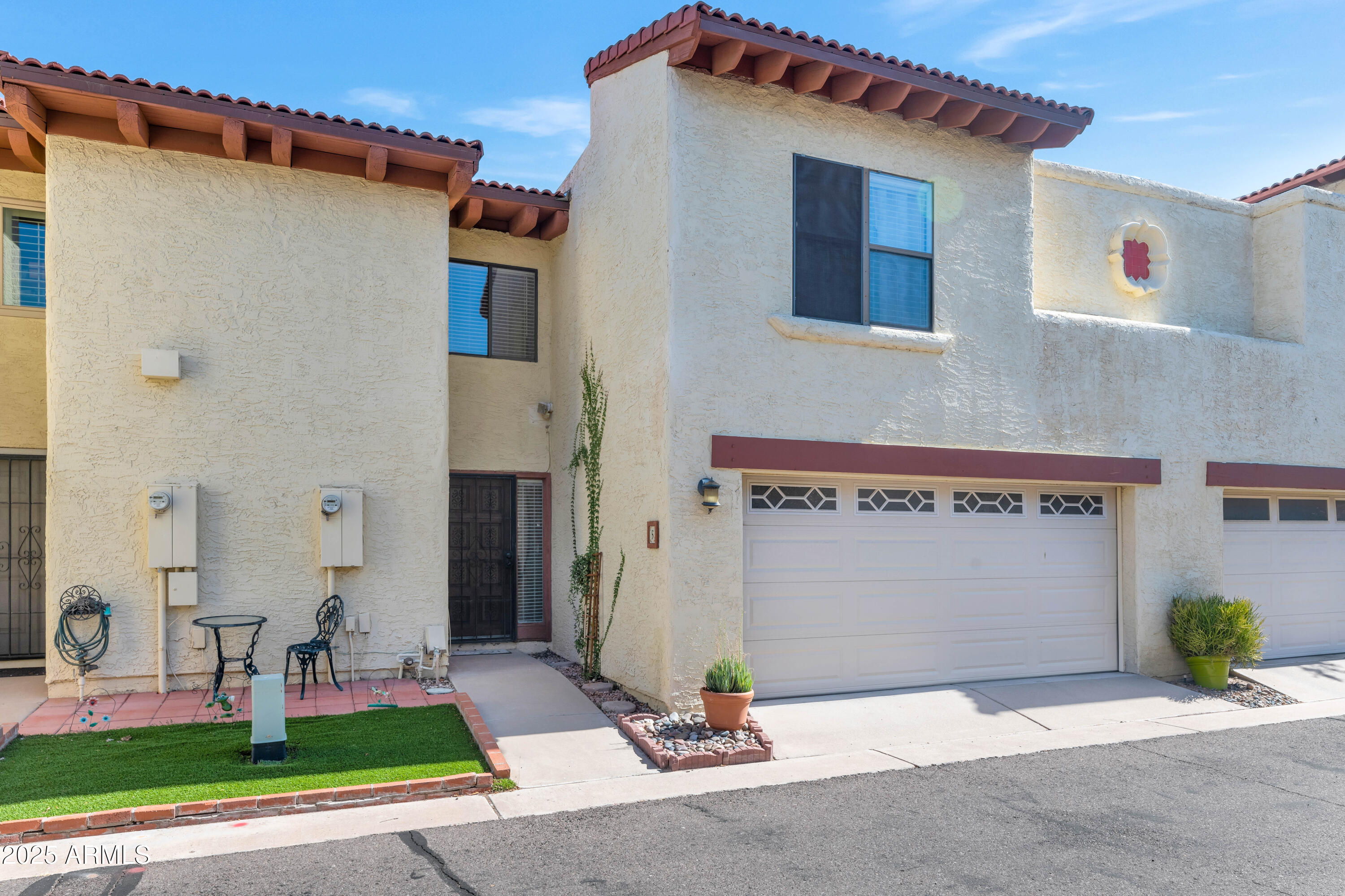 5726 North 10th Street, Unit 5 Phoenix, AZ 85014 - Photo 29 of 39 a front view of a house with a yard and garage