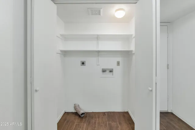 a view of walk in closet with empty racks