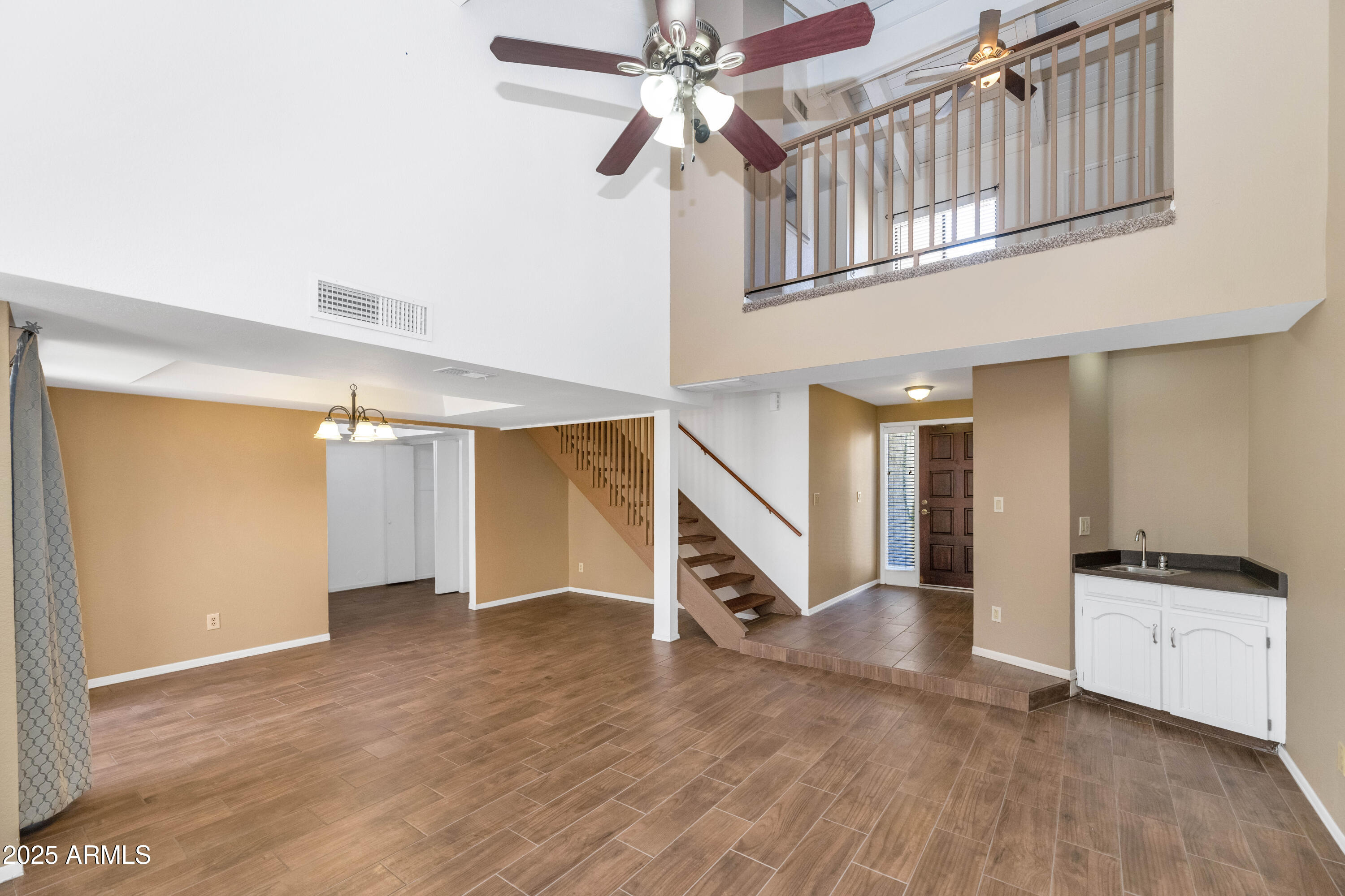5726 North 10th Street, Unit 5 Phoenix, AZ 85014 - Photo 3 of 39 a view of an empty room with stairs and a ceiling fan