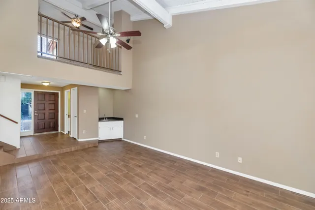 a view of an empty room with a fan