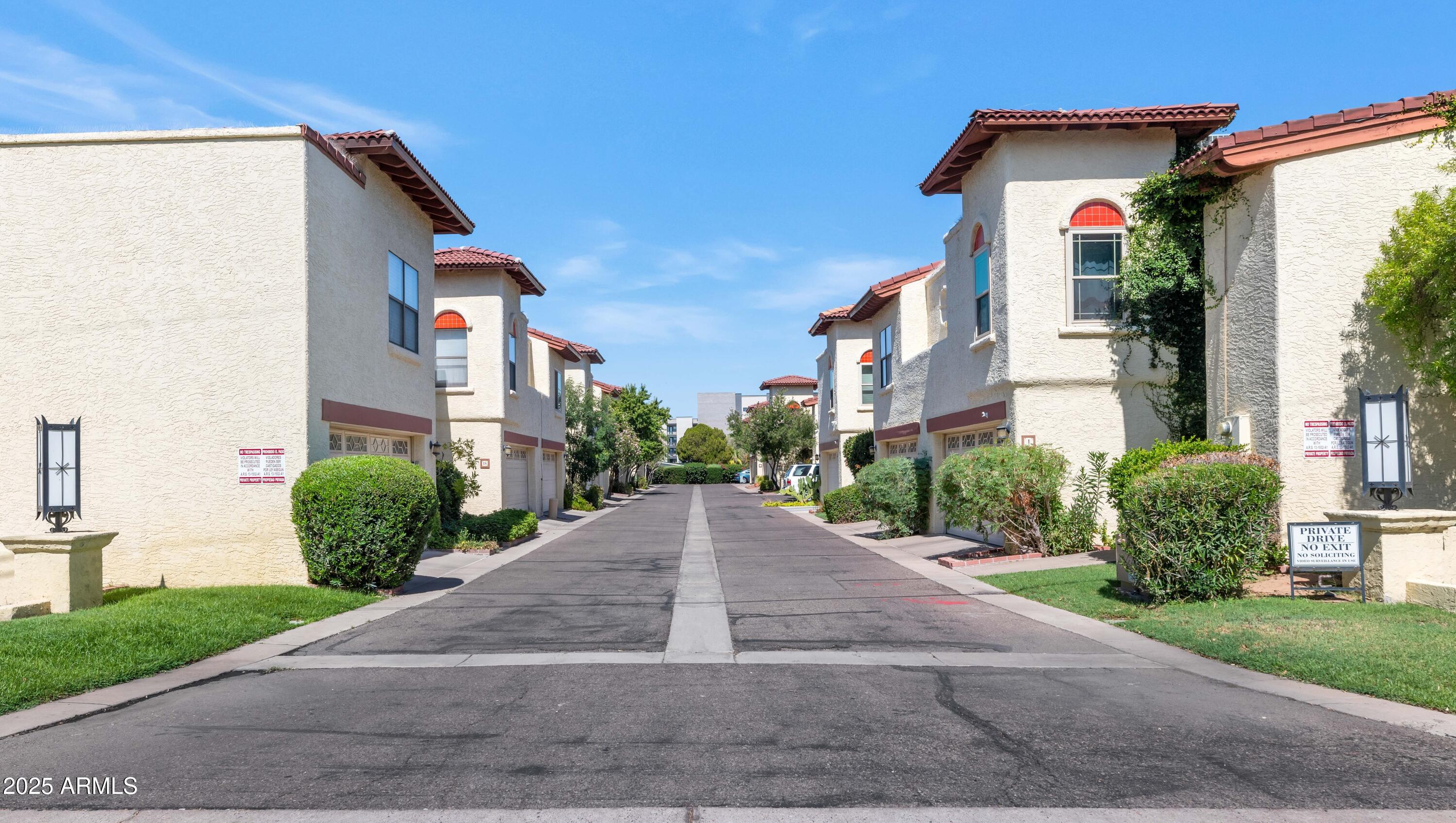 5726 North 10th Street, Unit 5 Phoenix, AZ 85014 - Photo 38 of 39 a front view of a house with a yard and garage