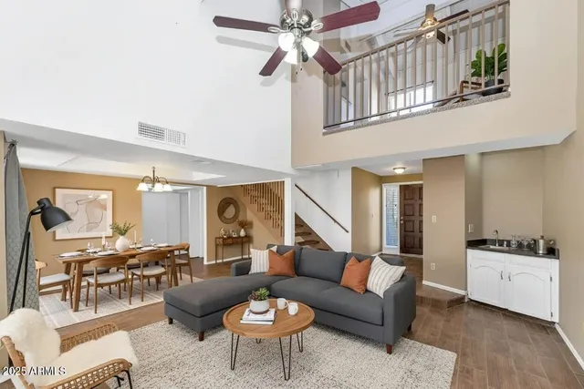 a living room with furniture and a chandelier