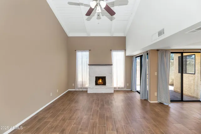 wooden floor fireplace and windows in a room