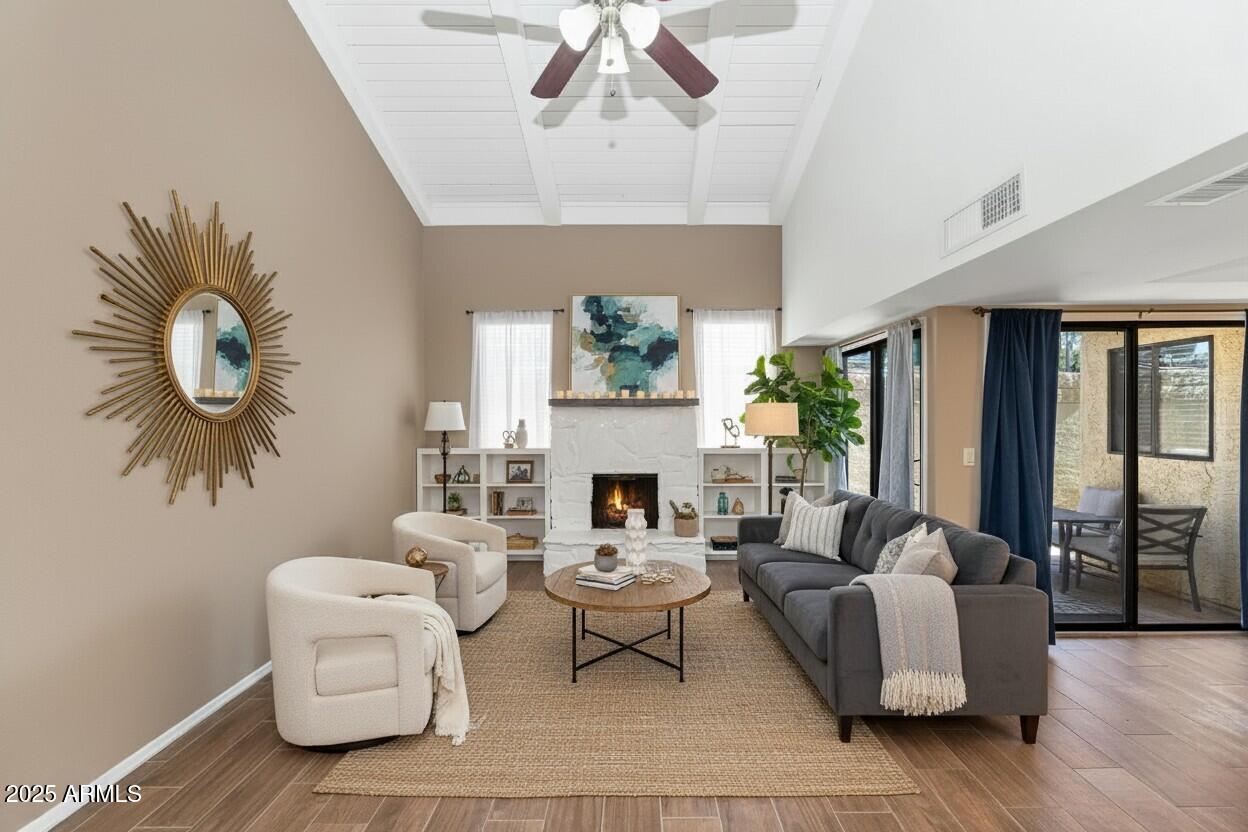 5726 North 10th Street, Unit 5 Phoenix, AZ 85014 - Photo 6 of 39 a living room with furniture a fireplace and a chandelier
