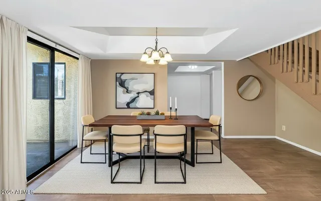 a view of a dining room with furniture and a chandelier
