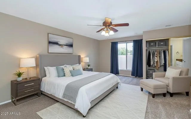 a bedroom with a bed and a chandelier