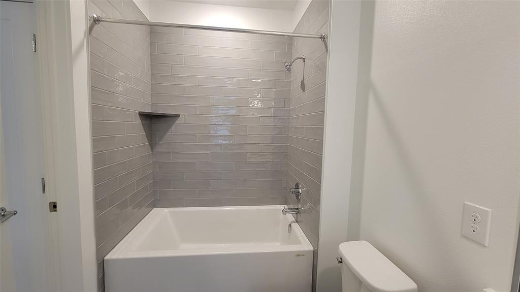 4801 Springdale Road, Unit 1202 Austin, TX 78723 - Photo 11 of 15 a bathroom with a bathtub and a toilet