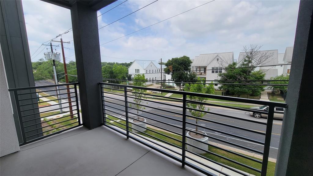 4801 Springdale Road, Unit 1202 Austin, TX 78723 - Photo 15 of 15 a view of a balcony with a couple of cars parked in parking lot