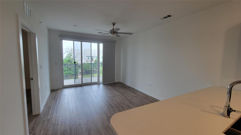 4801 Springdale Road, Unit 1202 Austin, TX 78723 - Photo 2 of 15 a view of a livingroom with wooden floor and a ceiling fan